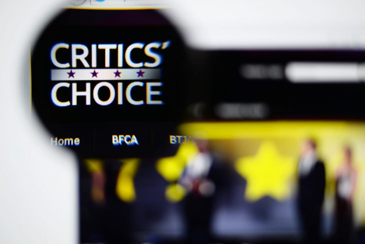 LISBON, PORTUGAL - NOVEMBER 17, 2014: Photo of Critics' Choice Awards homepage on a monitor screen through a magnifying glass.