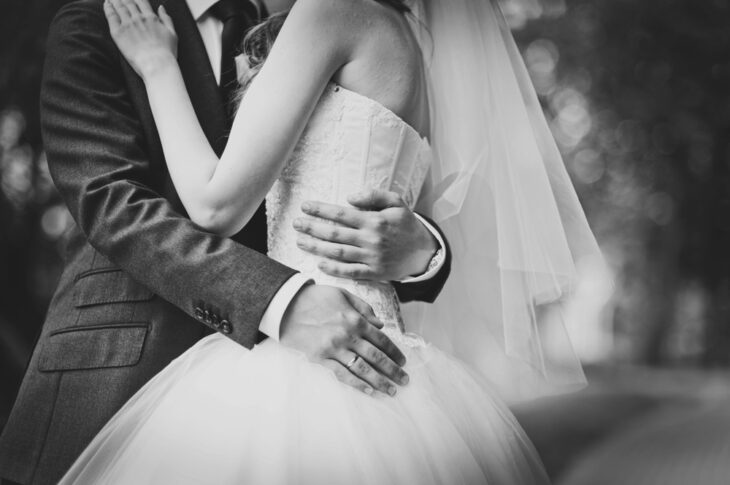 Couple holding hands at wedding